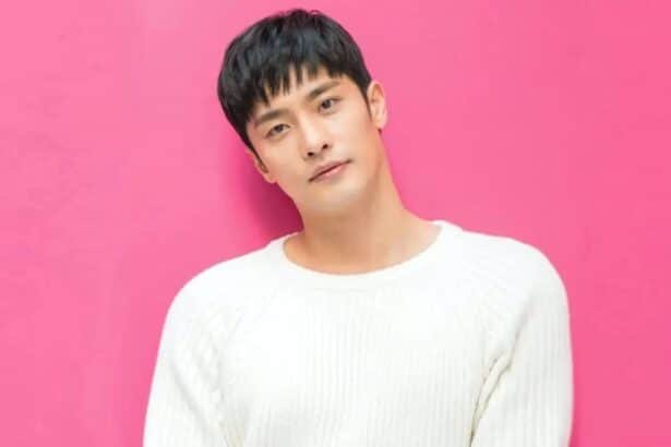 sung hoon behind a pink back-drop