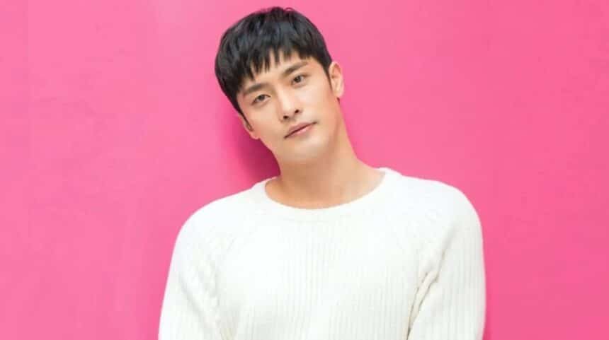 sung hoon behind a pink back-drop